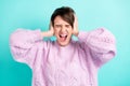 Photo of upset annoyed young woman wear violet sweater arms close ears isolated turquoise color background
