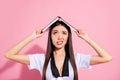 Photo of upset lady hold book above head hiding from rain drops oh no wear specs white top red skirt isolated pink