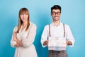 Photo of upset unhappy two persons dressed white clothes giving present arms crossed isolated blue color background