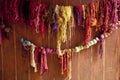 Variety of colored wools hanging on a wooden wall Royalty Free Stock Photo