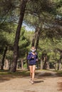 Photo vertical of a Fitness woman running with a mask in full panthemia of the covid respecting the safety distance