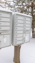 Photo Vertical Mailbox against neighbourhood landscape covered with fresh white snow in winter