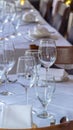 Photo Vertical Wine glasses spoons forks saucer plates and napkins on a table with white cloth