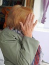 Camera shy woman hides face from photo Royalty Free Stock Photo