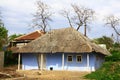 photo of very old house in country side with blue wallls