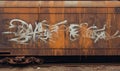 Photo of a vibrant yellow train car covered in colorful graffiti