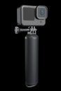 Photo and video lightweight action camera with monopod on black background