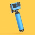 Photo and video lightweight blue action camera with monopod on orange background