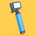 Photo and video lightweight blue action camera with monopod on orange background