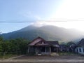 a photo of a view of a classic model house at the foot of Mount Telomoyo in the morning