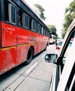 A view of red bus taken in traffic