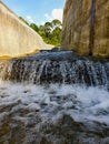 photo of a view of a stream of water with a tree background