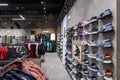 Minsk, Belarus - Nov 25, 2021: Photo of a view of a wall of sneakers and clothes inside the sports shop in the shopping