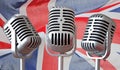 Vintage microphones trio withunion jack flag background Royalty Free Stock Photo