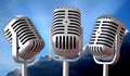 Vintage microphones trio with sun rays sky Royalty Free Stock Photo