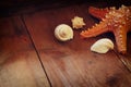 Photo of vintage decorative boat, sea shells and starfish on wooden old table. retro filtered image. marine background Royalty Free Stock Photo