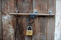 A photo of a vintage iron latch in an old wooden gate