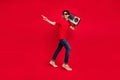 Photo of vintage party dancer guy carry boombox direct finger empty space wear red t-shirt red color background