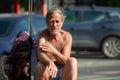 Old man sitting in the middle of the street Royalty Free Stock Photo