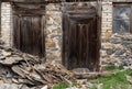 Old wooden doors of a ruined house