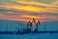 The pumping units sunset in winter in Daqing oil fields Royalty Free Stock Photo