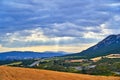 Colorful hills hit by sunrays filtering through the clouds in Navarra, Spain