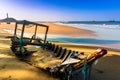 Seascape with A Broken Old Fishing Boat on Sandy Beach in Morning Sunshine Royalty Free Stock Photo