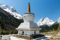 The white pagoda and snow mountains  in Four Girls Mountain scenic spot Royalty Free Stock Photo
