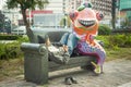 Tainan/Taiwan-13.03.2018:The funny statue and sleeping homeless man