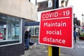 Covid-19 maintain social distance sign on UK shopping street Royalty Free Stock Photo