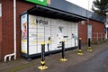 InPost online shopping pickup point with parcel lockers outside petrol station