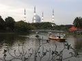 The boat at Shah Alam lake with the mosque as a background Royalty Free Stock Photo