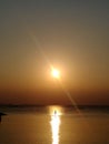 Man canoeing at the silent and calm sea under the golden sunset alone Royalty Free Stock Photo