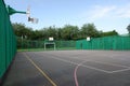 Multi-use sports court with basketball nets and football goals