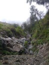This is a photo of someone on the slopes of Mount Arjuno, Gumandar Waterfall when it recedes Royalty Free Stock Photo