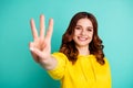 Photo of wavy curly charming fascinating gorgeous girlfriend smiling toothily showing you three fingers sign isolated Royalty Free Stock Photo