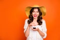 Photo of wavy curly cheerful positive nice pretty sweet youngster licking her upper lip holding cherry with her hand