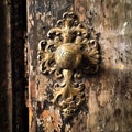 A photo of a weathered brass doorknob of an ancient house