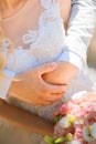 Photo of a wedding couple in the summer. Bride and groom hugging, hands, rings, wedding bouquet close-up and copy space Royalty Free Stock Photo