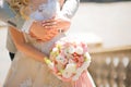 Photo of a wedding couple in the summer. Bride and groom hugging, hands, rings, wedding bouquet close-up and copy space Royalty Free Stock Photo