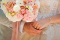 Photo of a wedding couple in the summer. Bride and groom hugging, hands, rings, wedding bouquet close-up and copy space Royalty Free Stock Photo