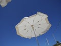 White beach umbrellas against the blue sky. Marfa, Mellieha, Malta Royalty Free Stock Photo