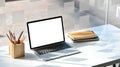 Photo of white blank screen computer laptop putting together with stack of books and pencil holder. Royalty Free Stock Photo