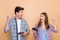 Photo of white cheerful positive beautiful stylish trendy couple of two people playing playstation with joysticks having Royalty Free Stock Photo