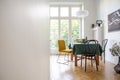 Photo of white dining room interior with herringbone