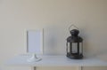 Photo White Frame on a wooden and Lantern on wall background .