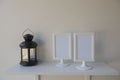 Photo White Frame on a wooden and Lantern on wall background .