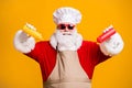 Photo of white grey hair beard santa claus in chef cap squeeze bottle ketchup mustard x-mas christmas eve feast wear
