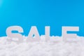 Photo of white letters of word sale standing under blue sky background festive christmas season tradition x-mas commerce