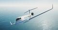 Photo of white luxury generic design private airplane flying over the sea. Empty blue sky at background. Luxury travel Royalty Free Stock Photo